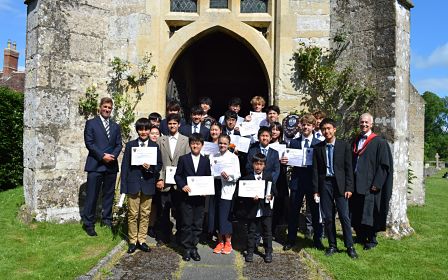 group of school boys holding certificates