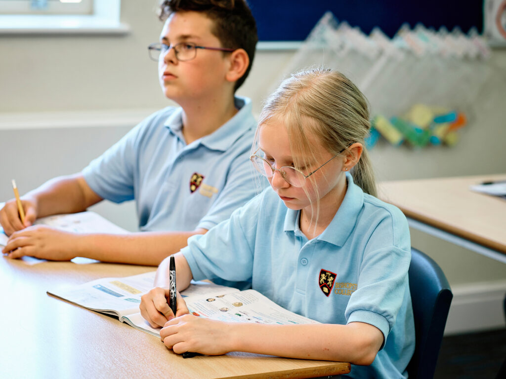 Bishopstrow Partner Schools, shows two students sat studying.