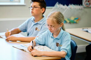 Bishopstrow Partner Schools, shows two students sat studying.